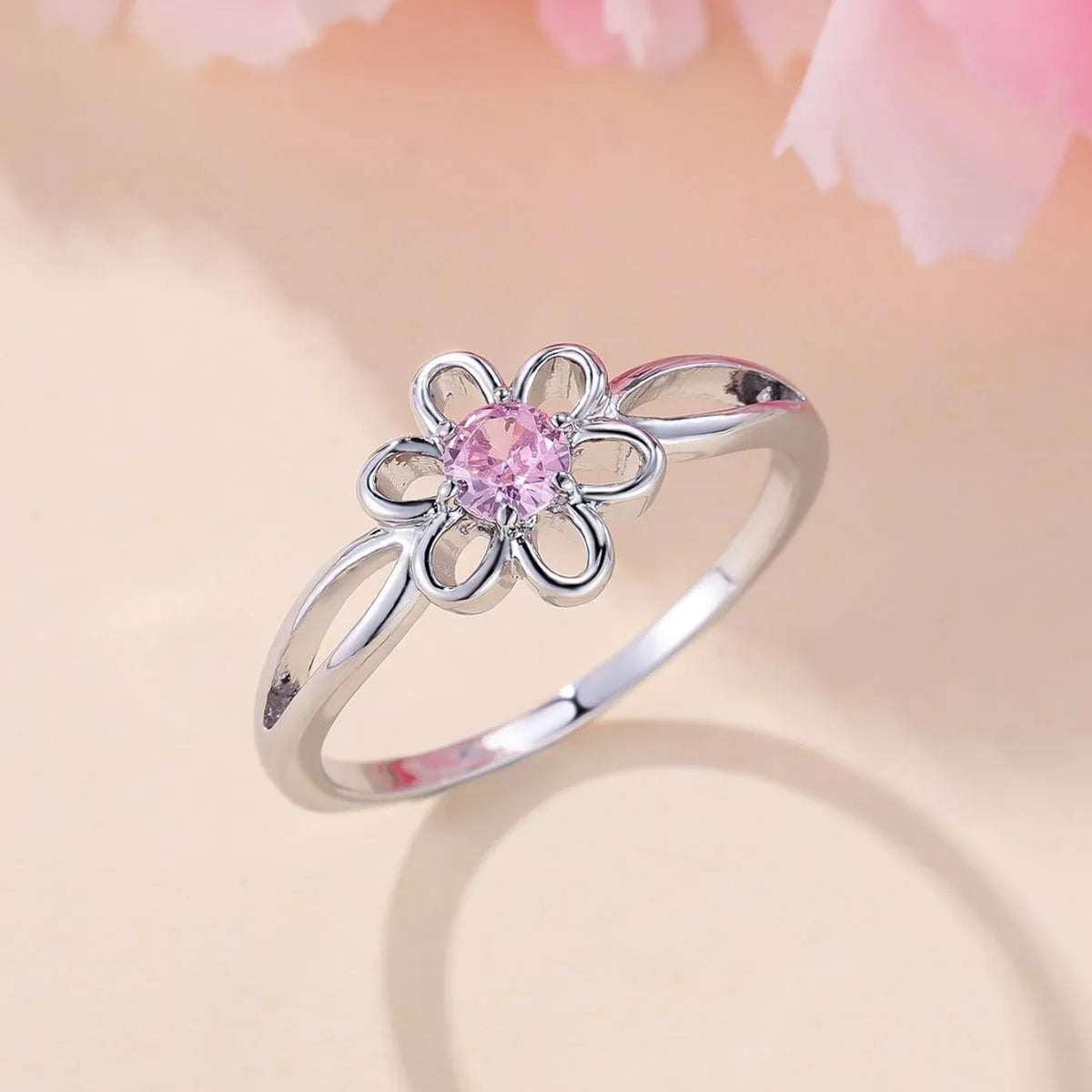 Women's hollowed flower fashion ring in copper with electroplated finish on a size chart.