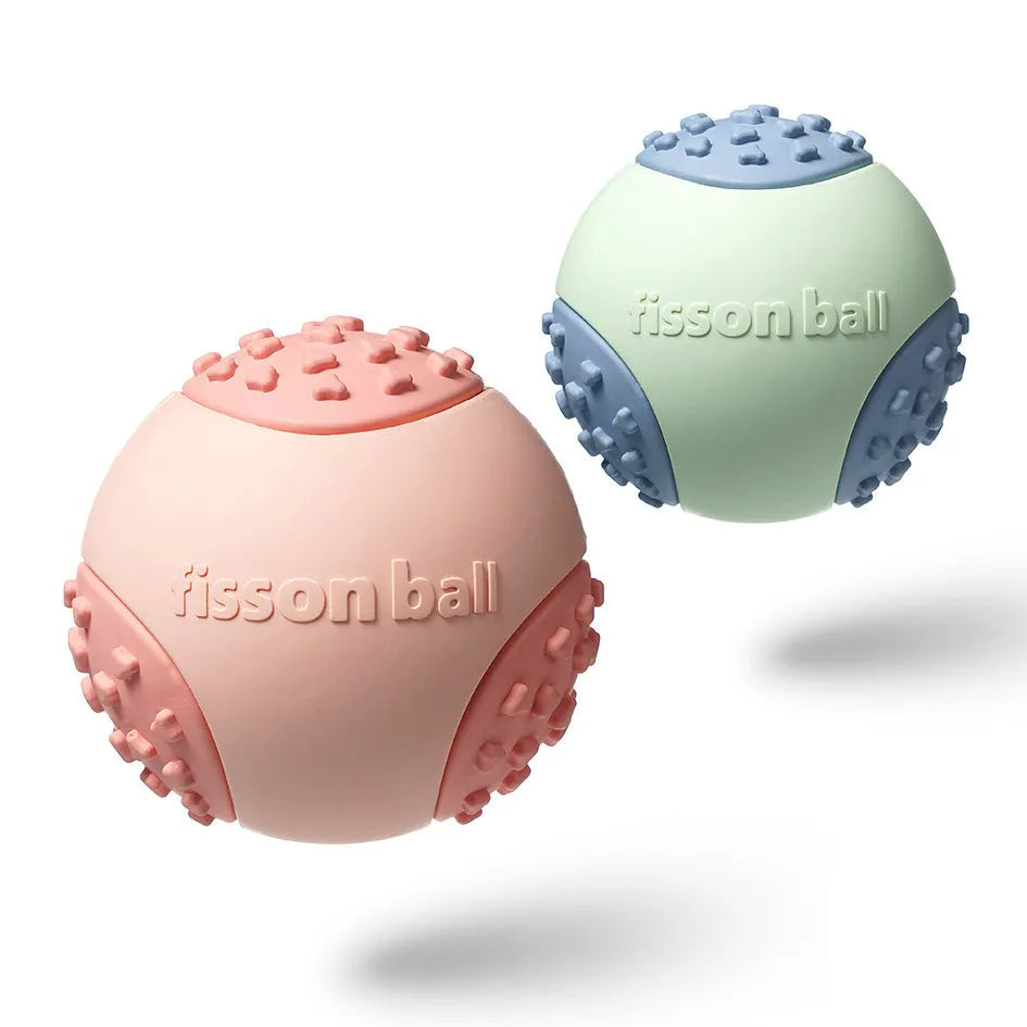 Green and pink dog rolling ball toy showing 64mm diameter size for small and medium breeds