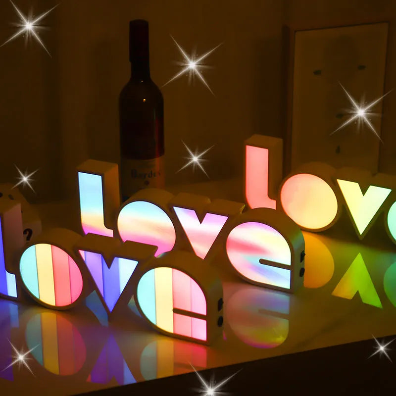 LED LOVE Light with colourful rainbow lampshade on a desk
