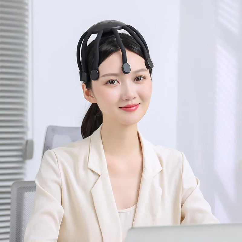 A handheld USB-powered head massager with multiple claws for scalp vibration and relaxation.