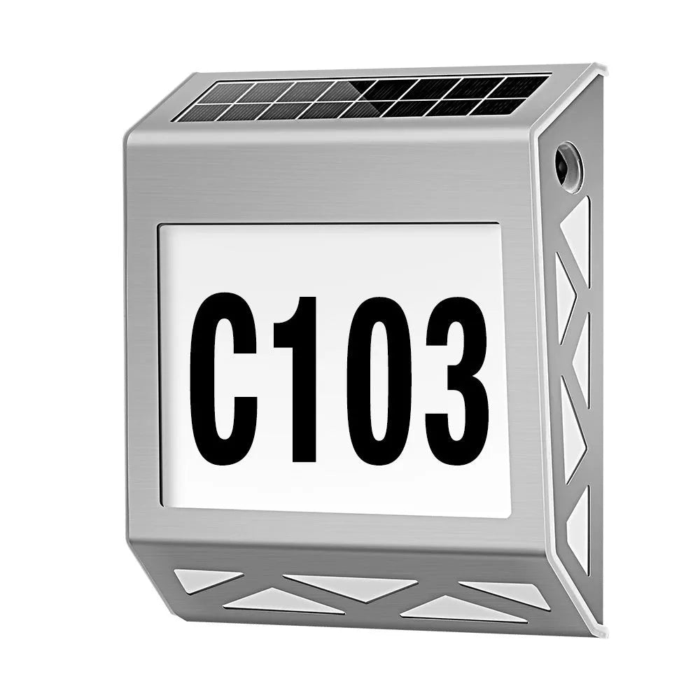 Black solar-powered outdoor doorplate light with digital LED number display mounted on a wall