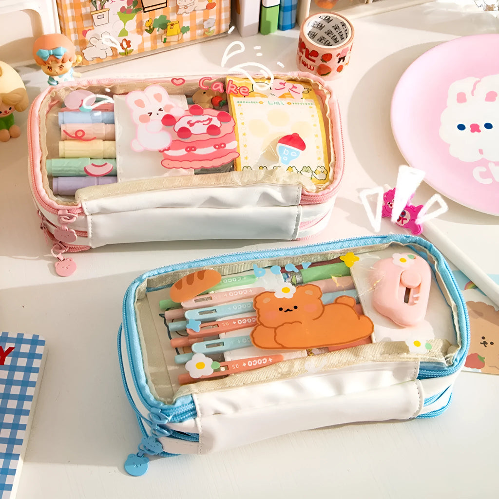 Transparent heart-shaped TPU pencil case in a pink multicolour Korean-style design with cake and rabbit motifs.