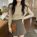 Beige long-sleeved viscose knitted cardigan hanging on a hanger, loose fit