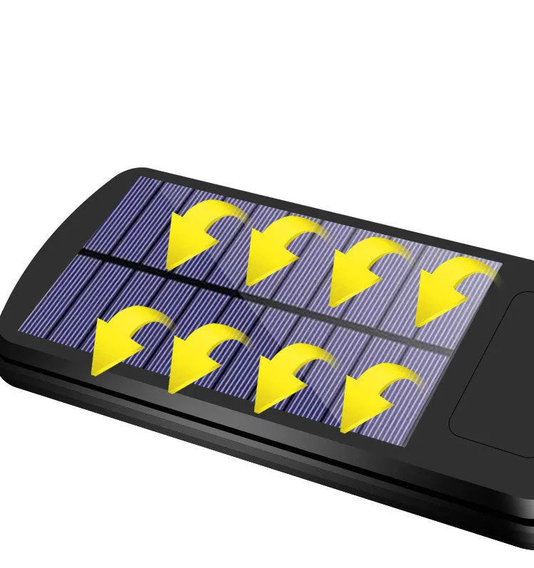 Black outdoor solar motion sensor security light mounted on a wall or fence post.