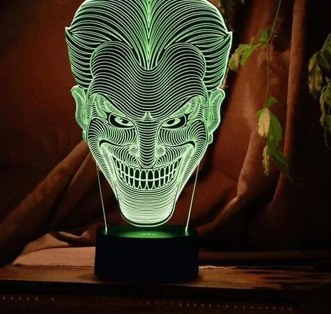 USB-powered 3D acrylic LED table lamp with remote control on a desk, displaying a gradient colour mode.
