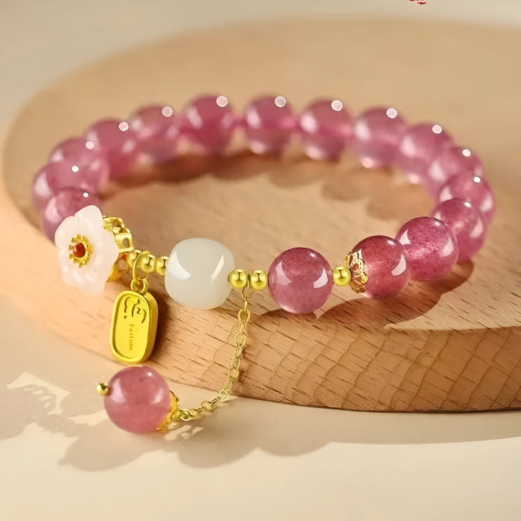 Handmade women's strawberry quartz crystal bracelet with pearl, moon, and XINGX designs