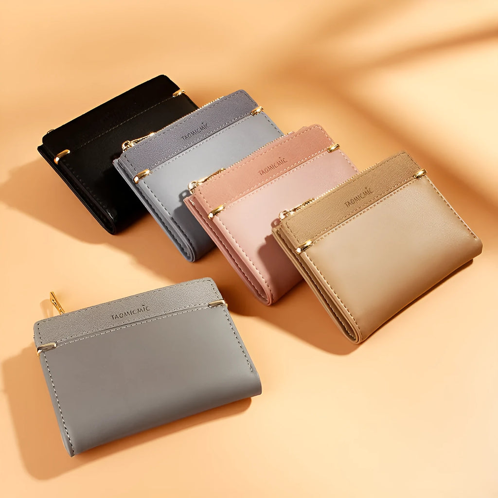 A closed black PU leather ladies wallet with a short zipper, showing its two-fold design.