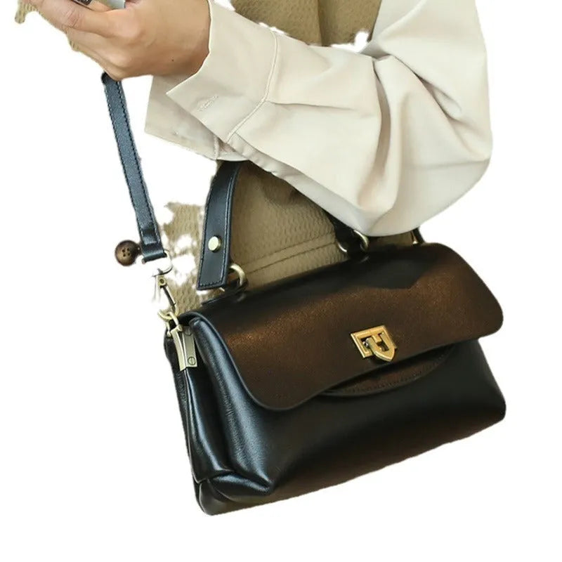A dark brown women's leather saddle handbag with visible stitching and an open front pocket.