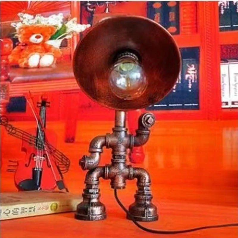 Iron pipe industrial retro robot design table lamp in retro colour on a wooden desk