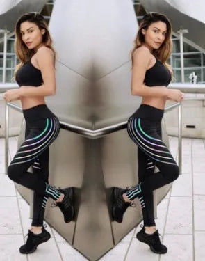Women's black workout leggings with a glowing print, shown in a slim-fit pencil pants style.