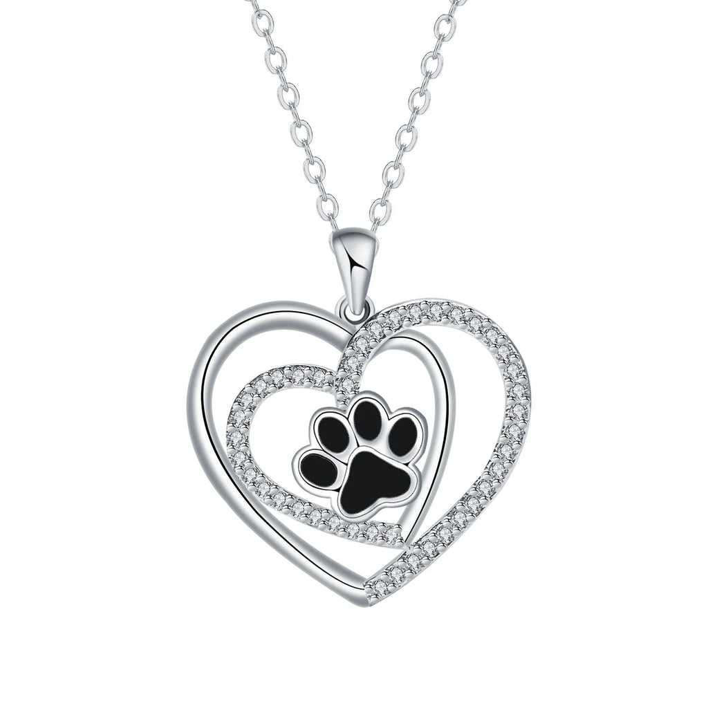 Women's copper necklace with a heart and dog paw prints pendant on a cross chain.