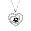 Women's copper necklace with a heart and dog paw prints pendant on a cross chain.