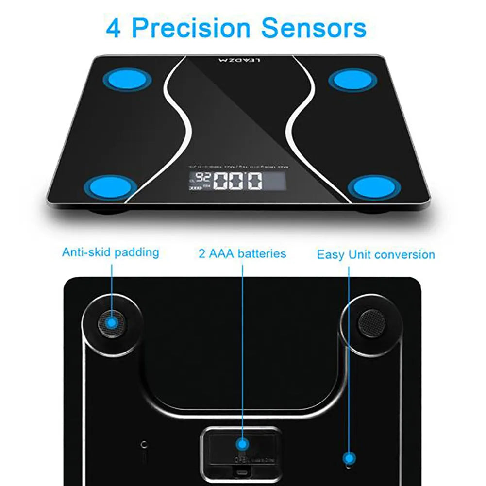 Black electronic personal body scale on a floor, showing digital display.