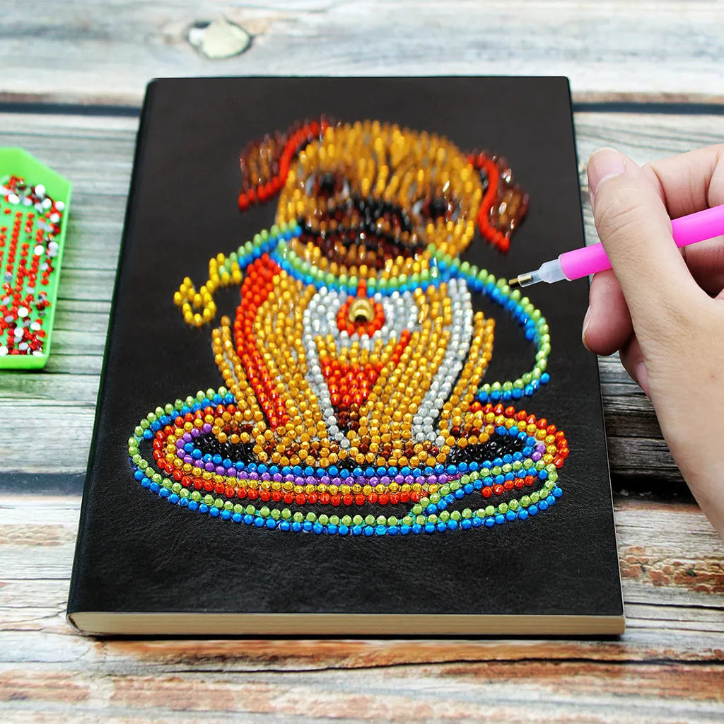 Black A5 diamond painting notebook with elastic closure showing open pages for craft organisation
