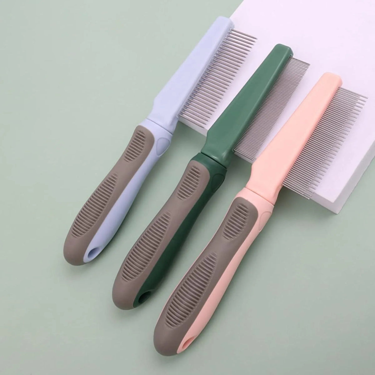 Blue pet detangler comb with three tooth configurations and rubber handle
