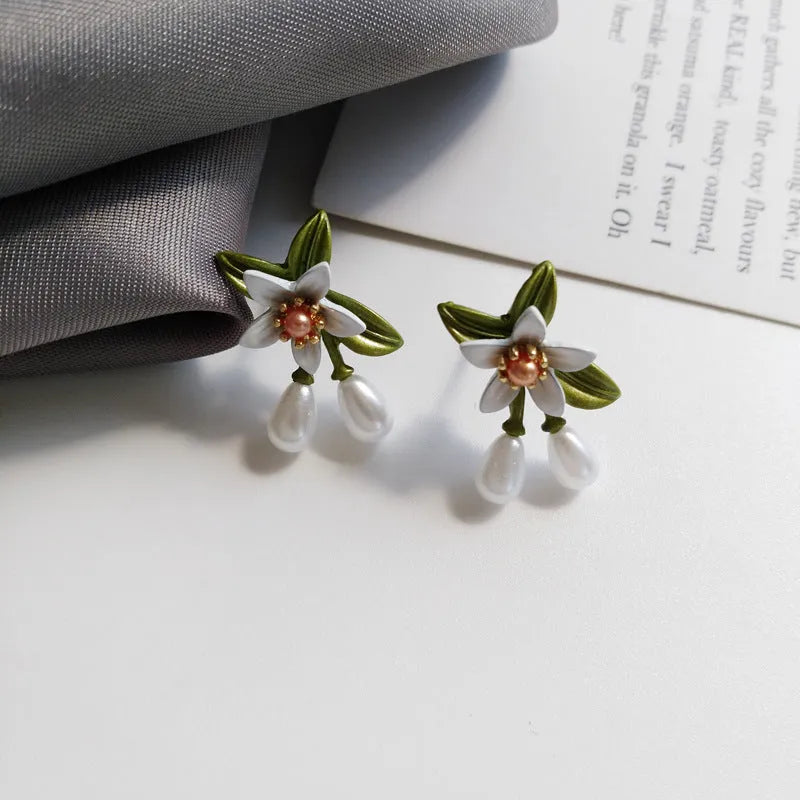 Alloy flower earrings for women, showing stud and clip styles with contrasting colour floral design.
