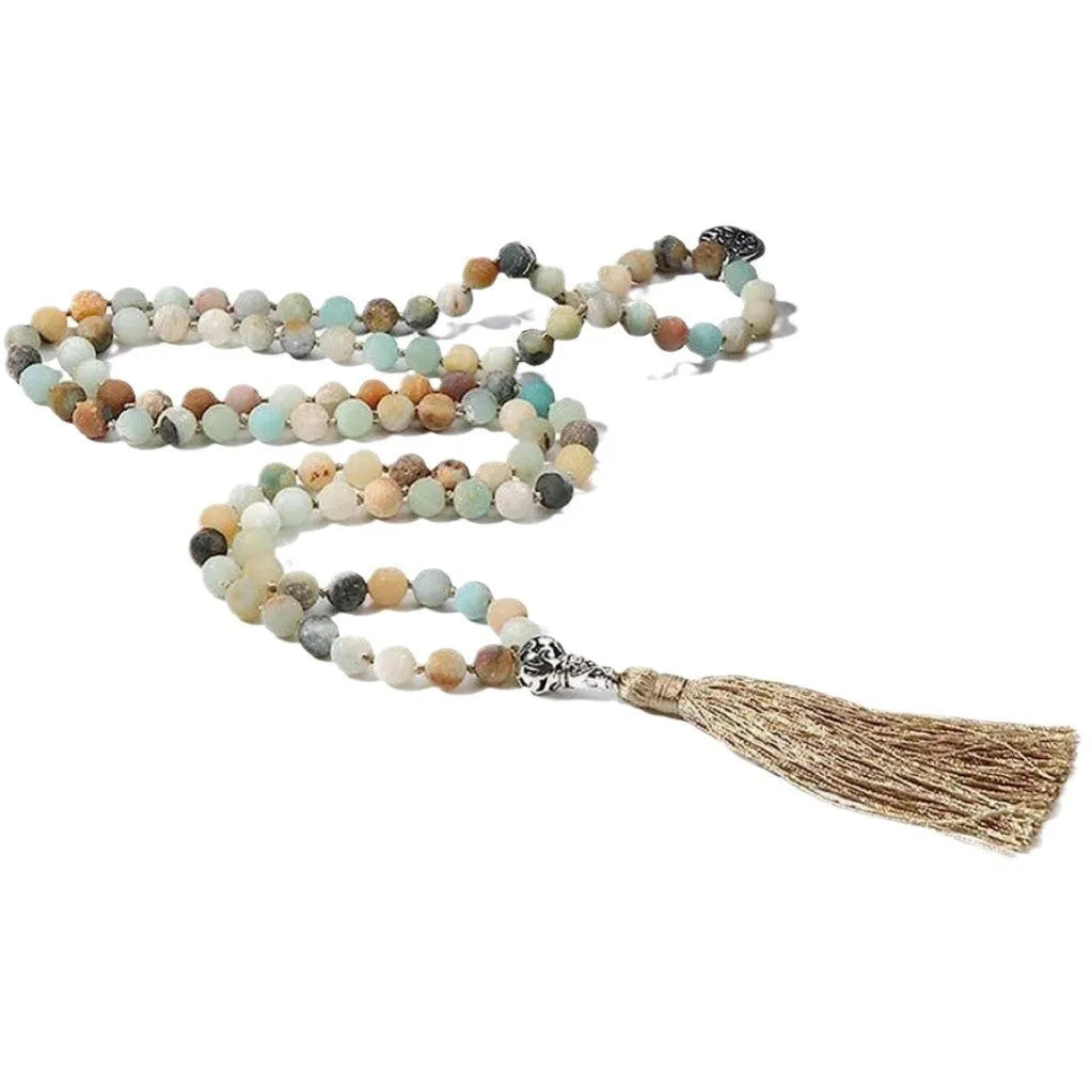 Handmade knotted beaded necklace with geometric stone pendant in natural colours.
