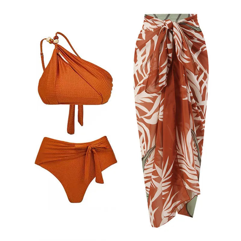 Brown women's high-waisted swimsuit with push-up top and a sheer black chiffon dress overlay.