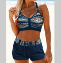 Women's navy blue and print polyester two-piece bikini swimsuit on a hanger.