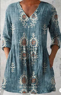 Women's loose-fitting floral print dress with 3/4 sleeves and a wide waist, shown on a hanger.