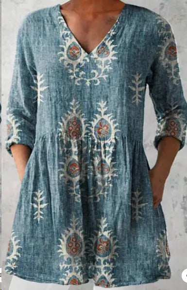 Women's loose-fitting floral print dress with 3/4 sleeves and a wide waist, shown on a hanger.