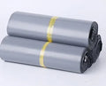 Clear plastic courier bag for clothing with self-adhesive sticker seal, shown in multiple sizes.