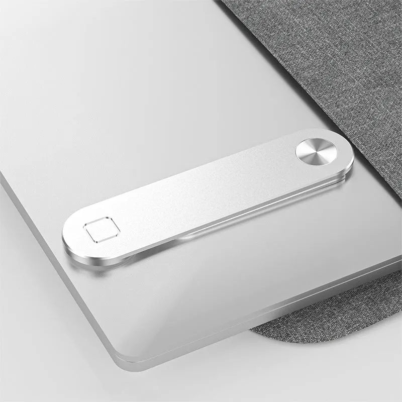 Black adjustable magnetic phone holder clipped to silver laptop showing phone mounted beside screen