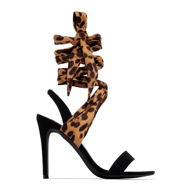 Light brown leopard print women's high-heeled sandals with Roman cross straps and a thin high heel.