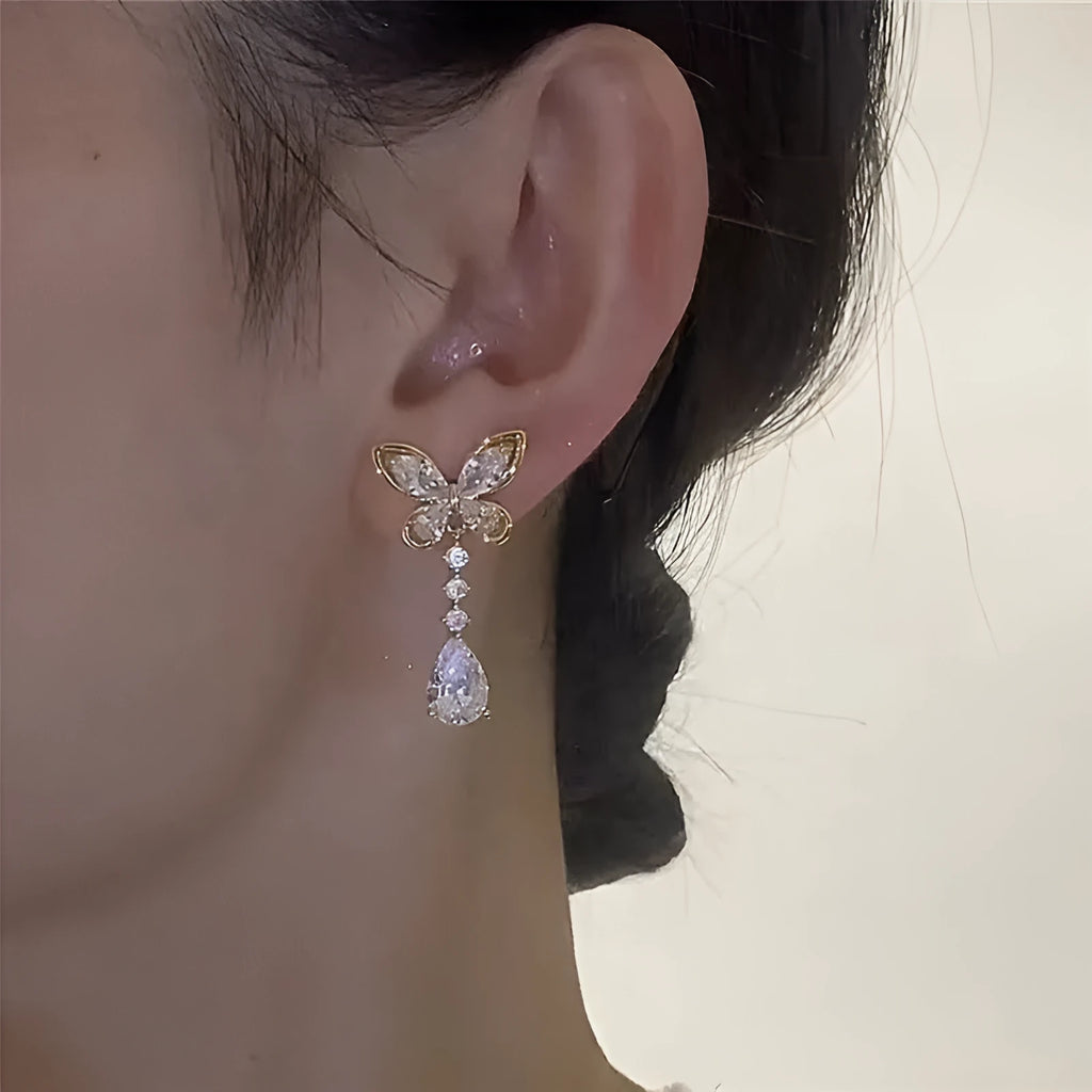 Women's platinum bow stud earrings with zinc alloy construction and electroplated finish