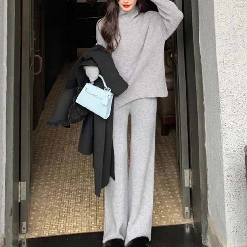 Women's milky white acrylic fibre sweater and wide-leg trousers two-piece set on a hanger.