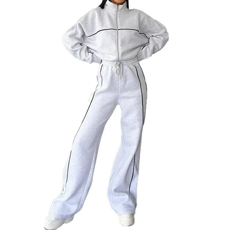 Casual two-piece suit set with a mock neck zip hoodie and striped trousers on a hanger.