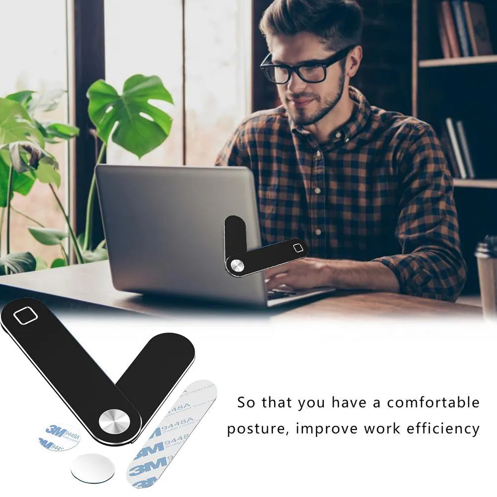 Black adjustable magnetic phone holder clipped to silver laptop showing phone mounted beside screen