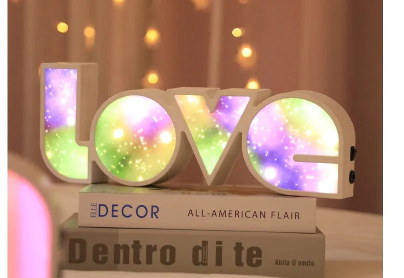 LED LOVE Light with colourful rainbow lampshade on a desk