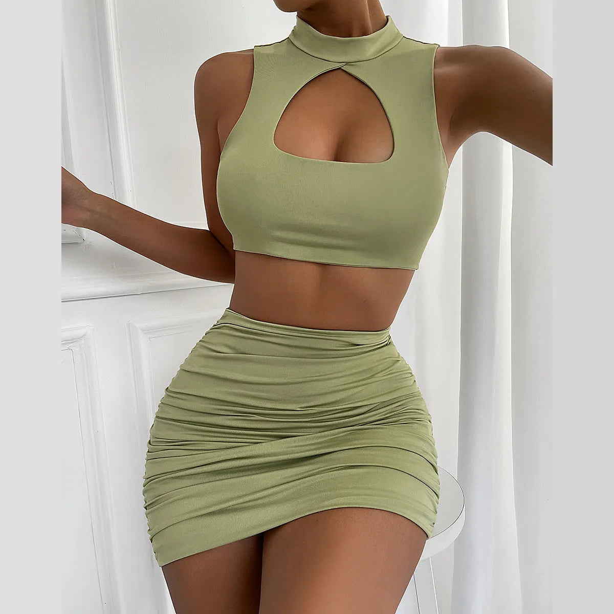 Women's light purple hollow vest and matching split skirt two-piece set on a model.