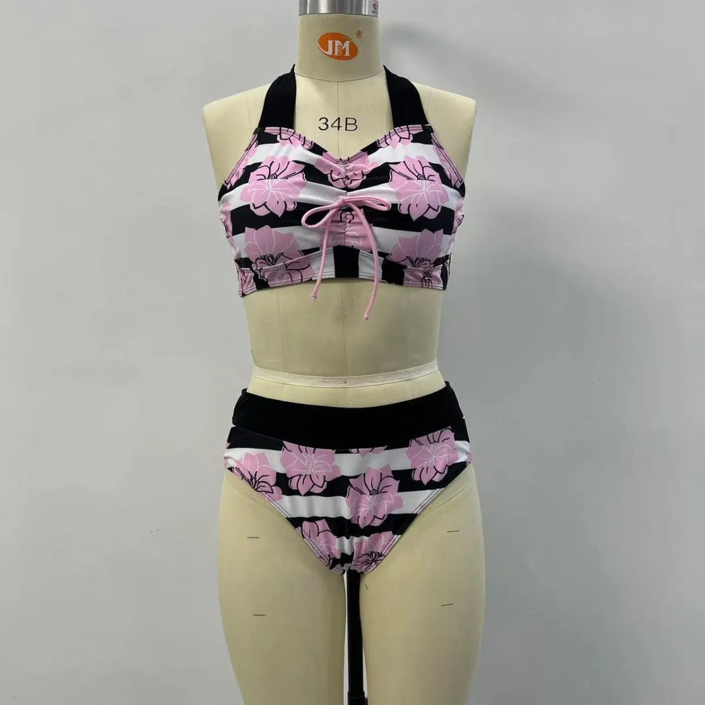 Black women's printed bikini with belly cover and split-leg design for swimming.