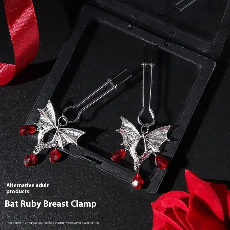 Silver coloured alloy bat-shaped nipple clamp with an adjustable screw mechanism.