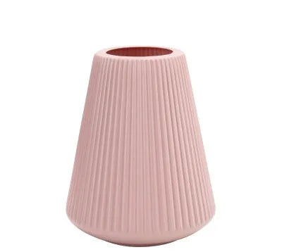 Colourful melamine plastic decorative flower vase on a tabletop.