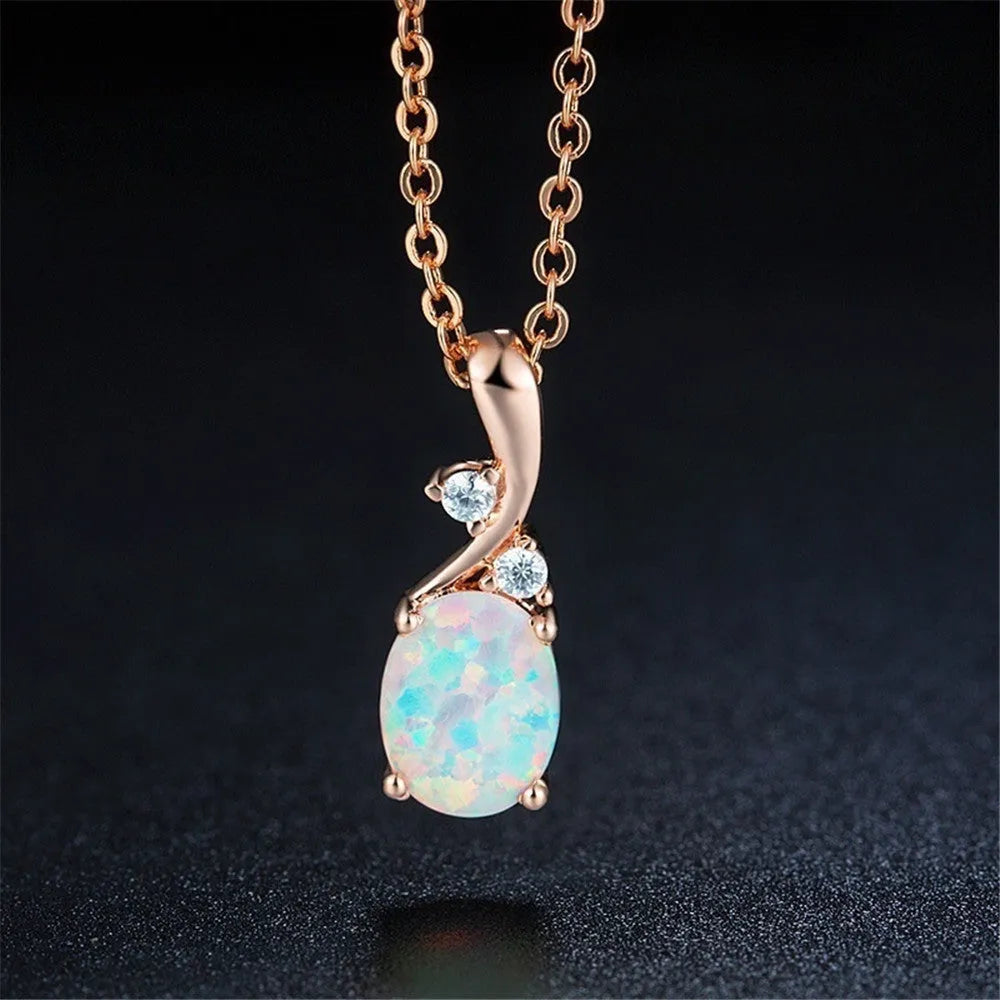 Water drop shaped opal pendant necklace on an O-chain in rose gold or white finish.
