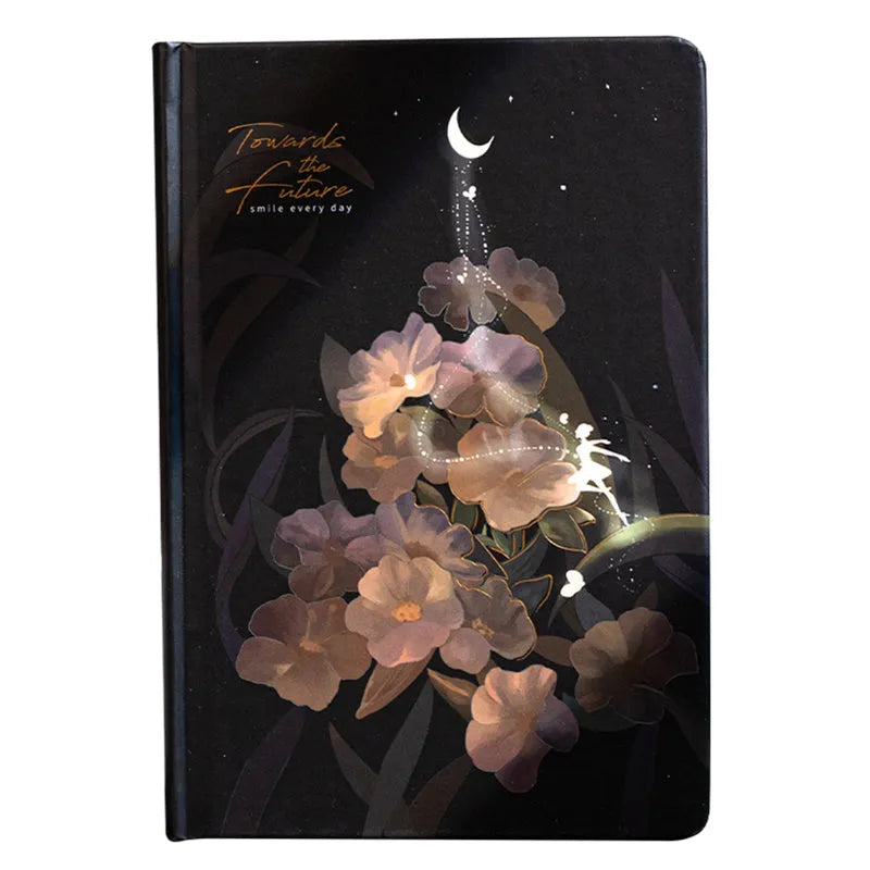 A5 notebook with a luminous cover open to show pages with colour illustrations, in deep blue, gold, light blue, or purple.