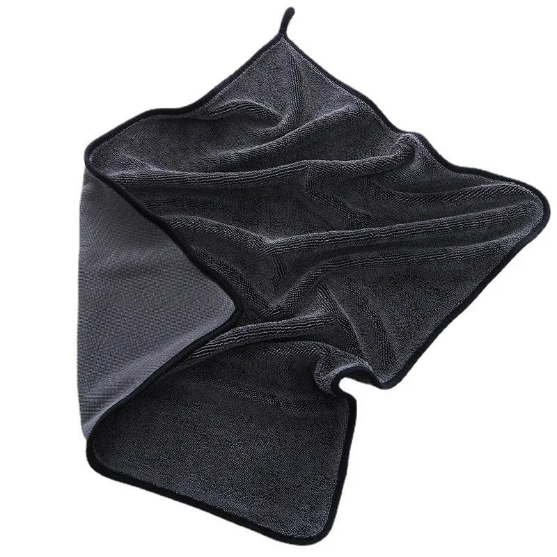 Grey car cleaning towel with black edge trim showing hemmed sides and spiral hair texture.
