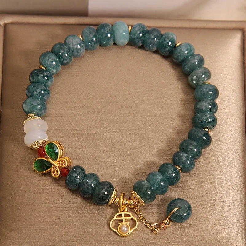 Blue water jade abacus bead crystal bracelet with butterfly charm and white agate beads