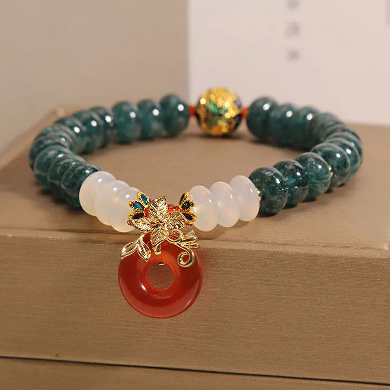 Blue jade and red agate bead bracelet with a crystal peace buckle closure.