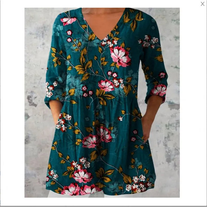 Women's loose-fitting floral print dress with 3/4 sleeves and a wide waist, shown on a hanger.