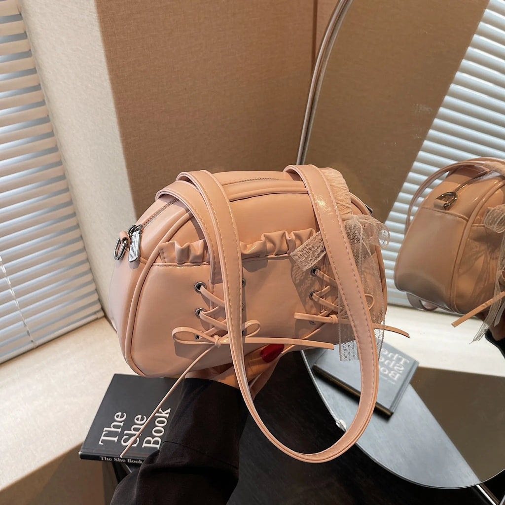 Women's milky white PU shoulder bag with bandage bow and stitching detail, showing internal phone pocket.