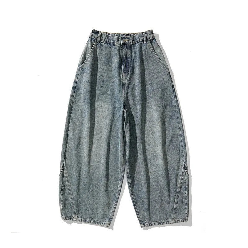 Men's loose fit light blue denim jeans with a straight leg and low waist, laid flat.