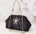Women's soft polyester messenger bag with diamond quilting and chain strap in black colour