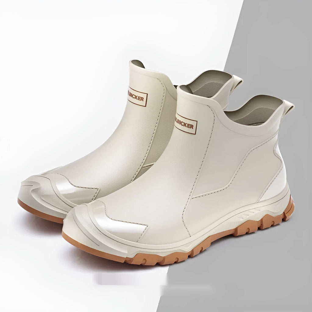 Short tube black PVC rain boots with round toe and flat heel on a non-slip plastic sole.
