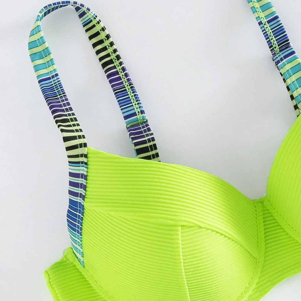 Green printed women's halterneck bikini top and split-style briefs set on a white background.