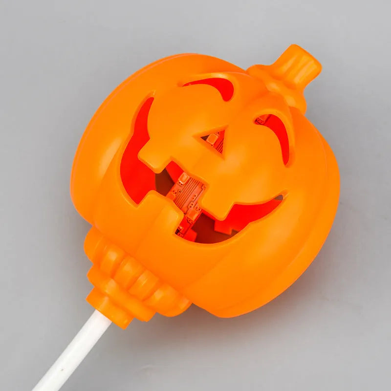 Plastic pumpkin-shaped USB rechargeable lamp glowing with either yellow or purple light, measuring 22cm tall.