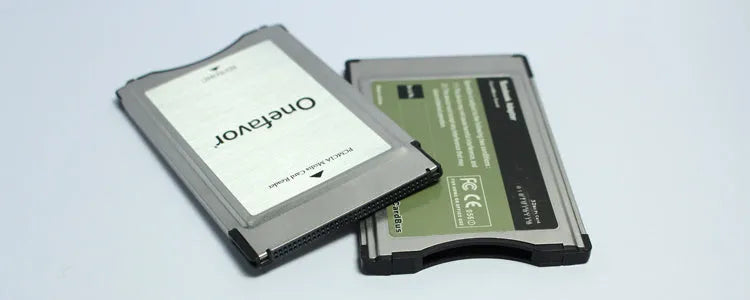 SD to PCMCIA adapter card with stainless steel housing for Mercedes-Benz cars next to a 32GB SDHC card
